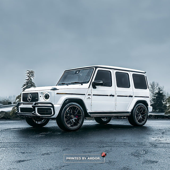 Mercedes-Benz G-Wagon wrapped in 3M satin white vinyl, parked on wet pavement