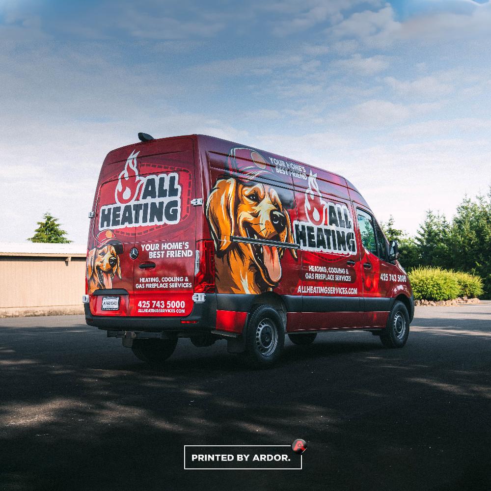 Rear view of All Heating van wrap featuring a large dog mascot, company logo, and contact info, promoting heating, cooling, and fireplace services.
