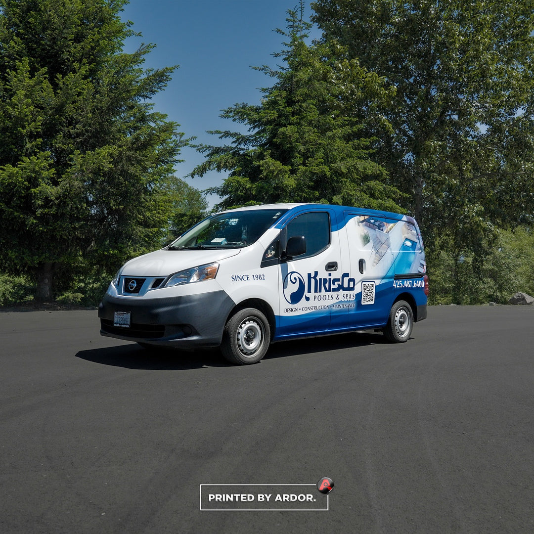 KrisCo Pools & Spas van with a blue and white custom wrap, advertising design, construction, and maintenance services, parked near trees.