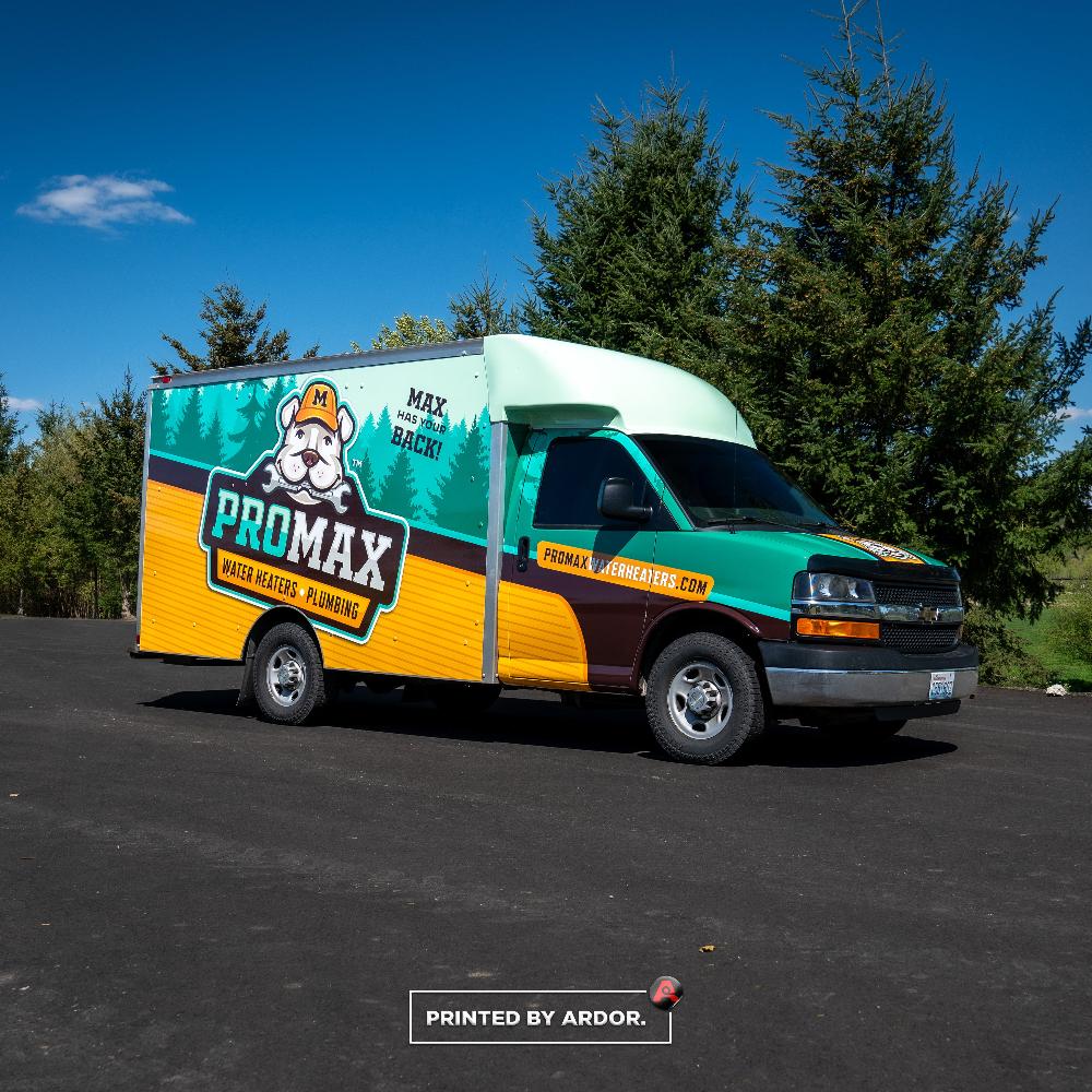 ProMax box truck featuring a colorful and bold wrap design advertising water heaters and plumbing services.