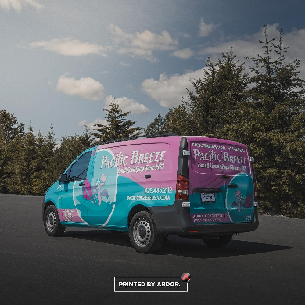 Rear and side view of Pacific Breeze van wrap featuring bright teal and pink design with the company’s logo and contact details.