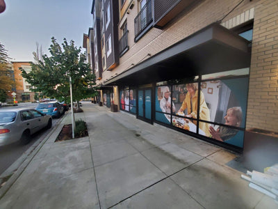 Large lifestyle photo window graphics on a commercial building by Ardor Printing