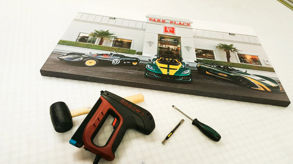 Stretched canvas print of the Park Place Motors dealership in Bellevue, WA, with three race cars parked in front of the showroom