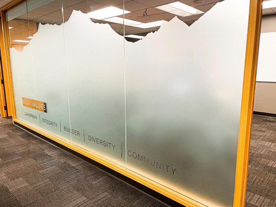 Custom-cut frosted window film with company values and mountain skyline on office glass by Ardor Printing