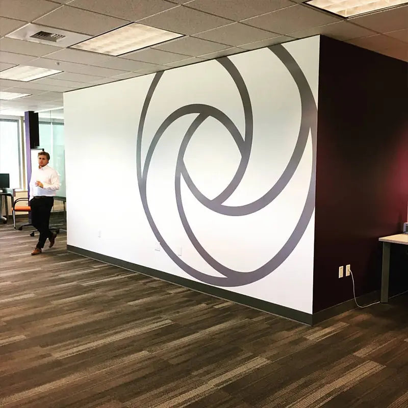 Large print and cut graphic we made for a new corporate office in Bellevue, WA. This project was done using grey computer cut 3M vinyl and installed to only cover half the wall.