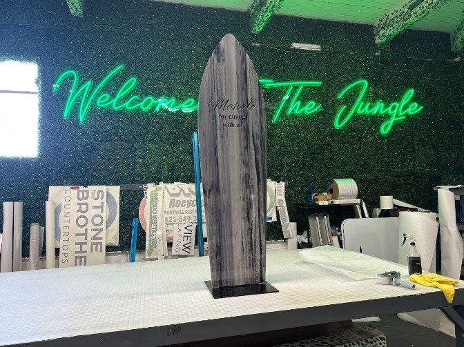 Surfboard-shaped acrylic signs by Ardor Printing