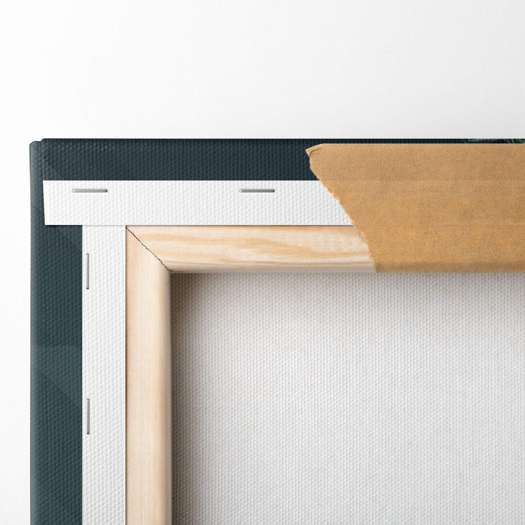 Top left-hand corner of the canvas print folded over the stretcher bars and stapled to the wood frame, revealing the high-quality.