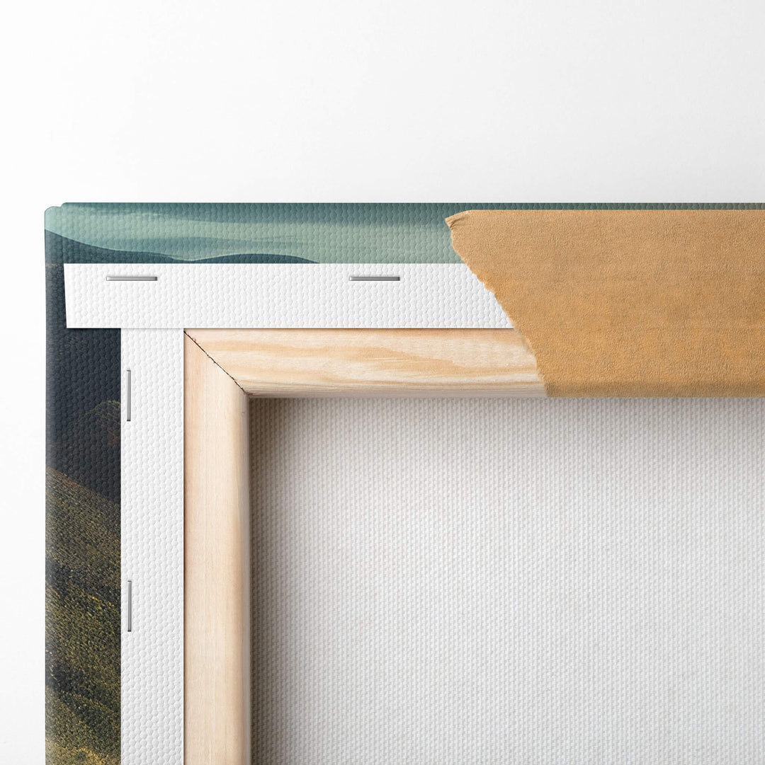 Detailed image of the back of the canvas print, top left hand corner folded over the stretcher bars and stapled to the wood frame.