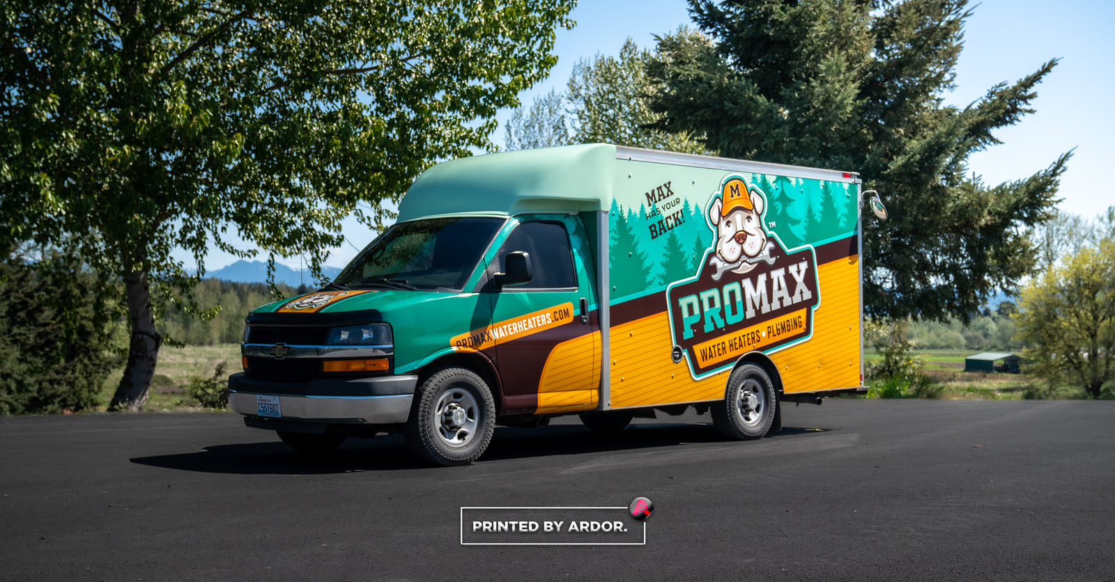 Chevrolet box truck wrapped in ProMax branding, showcasing bold colors and a friendly mascot for plumbing and water heater services.