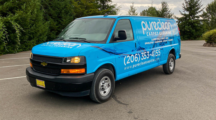 A baby blue Chevy Express van with a printed wrap, showcasing how long does it take to wrap a car by Ardor Printing