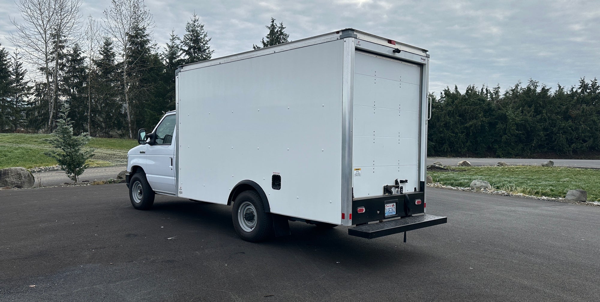 A plain white box truck with no graphics prepared to be have a printed vinyl wrap installed in Seattle, WA