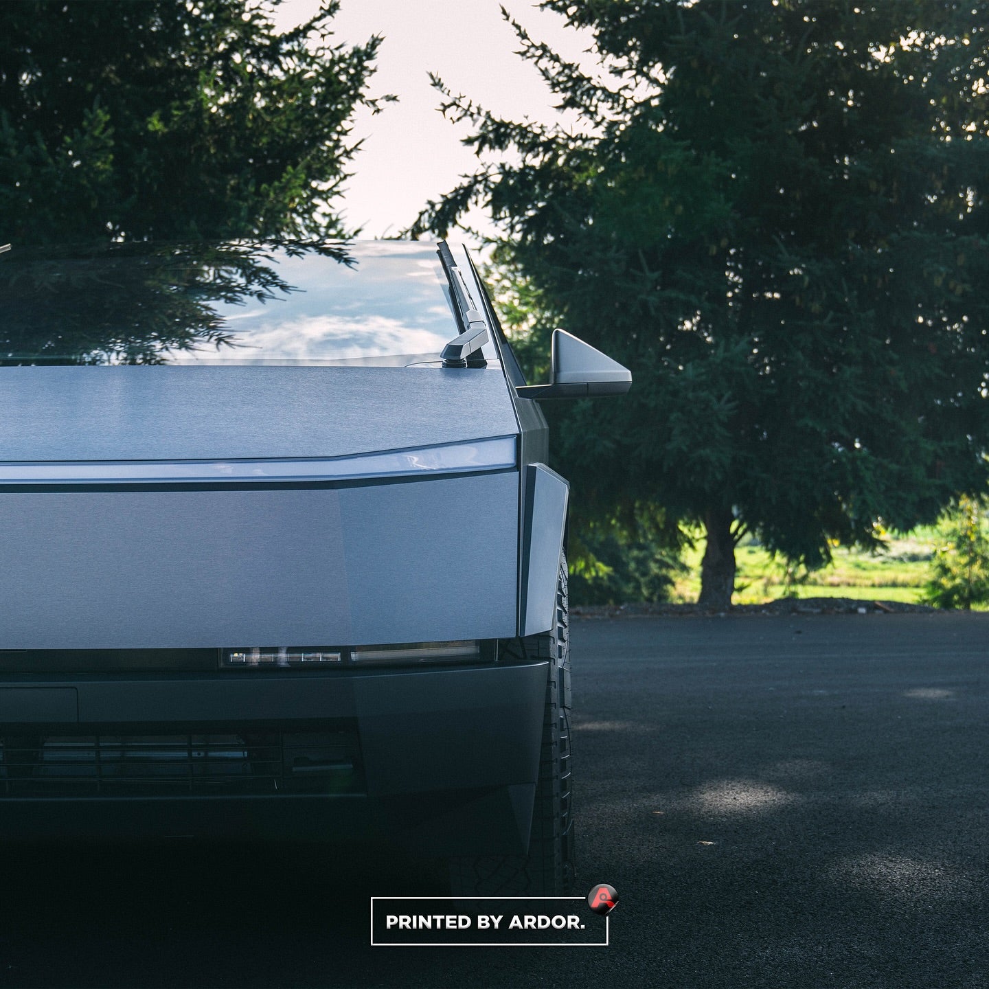 "Tesla Cybertruck with a desert sand wrap, blending with natural landscapes in a sleek style."