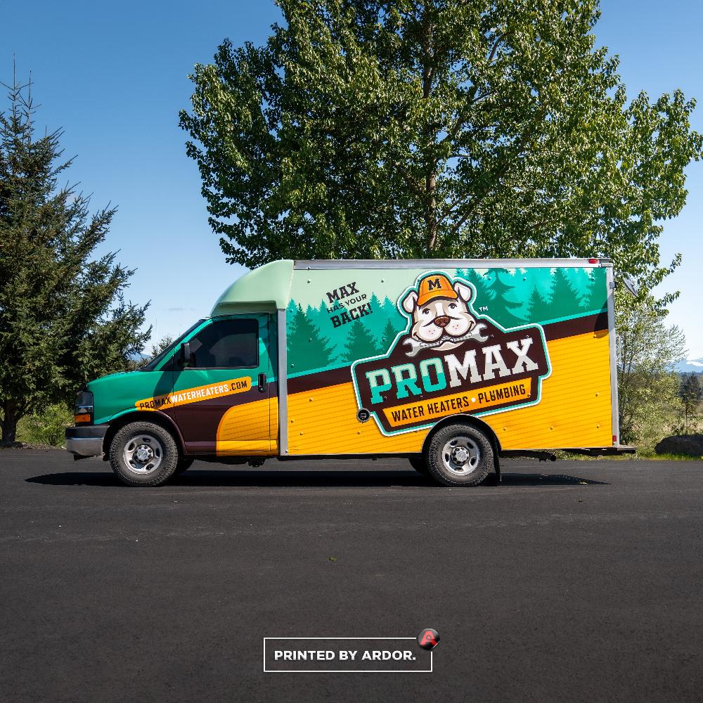 Side view of the ProMax box truck wrap featuring bright green and yellow colors, with mascot Max promoting water heaters and plumbing.