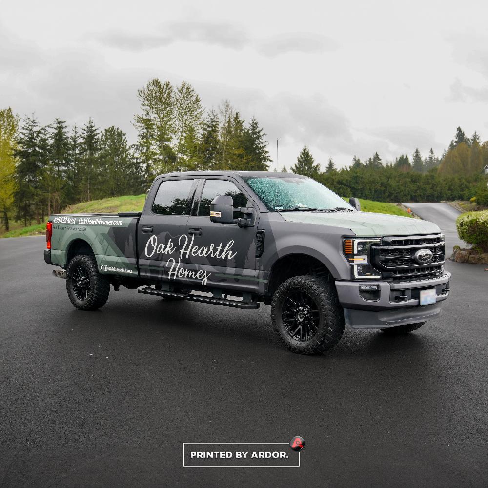 Front angle of Oak Hearth Homes’ custom wrapped truck, showcasing their real estate, remodel, and build services with stylish branding.