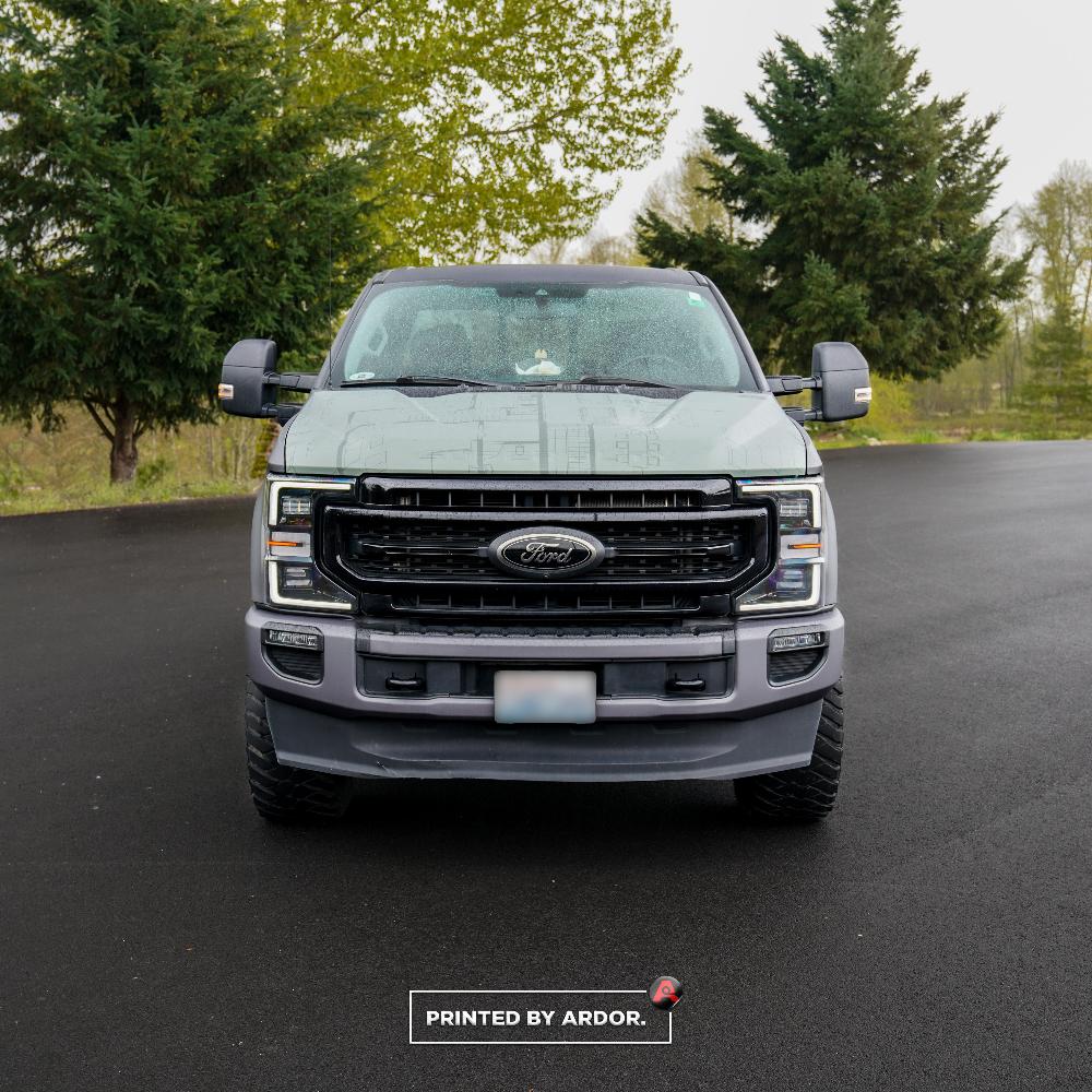 Front view Oak Hearth Ford truck wrap with a bold grille, captured in a professional setting on a rainy day