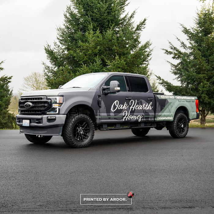 Oak Hearth Homes Ford F-250 pickup with a gray wrap and script logo, front three-quarter view