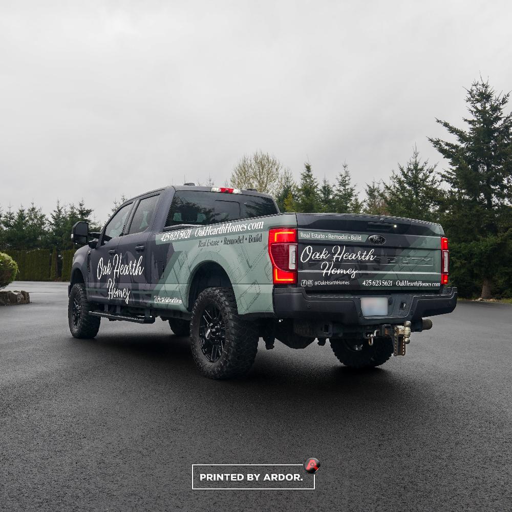 Oak Hearth Homes branded truck with custom wrap, showcasing sleek graphics for real estate and remodel services.