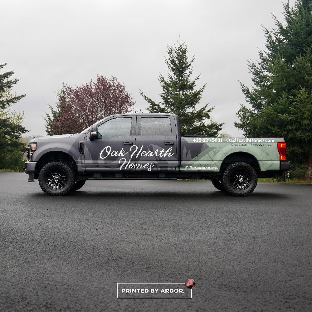 Oak Hearth Homes truck wrap displays clean branding with nature-inspired graphics, promoting real estate and remodeling services.