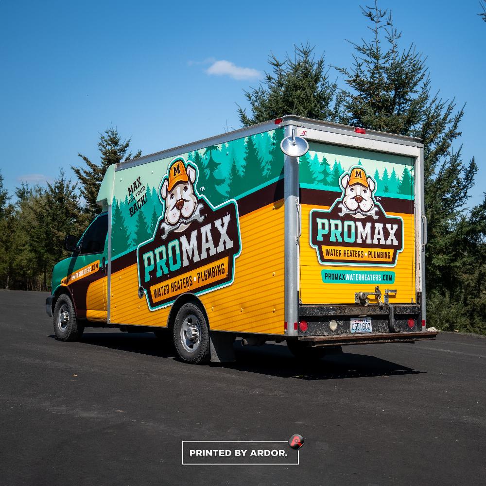 Bright ProMax box truck wrap showcasing a bulldog mascot and bold logo, advertising water heaters and plumbing services.