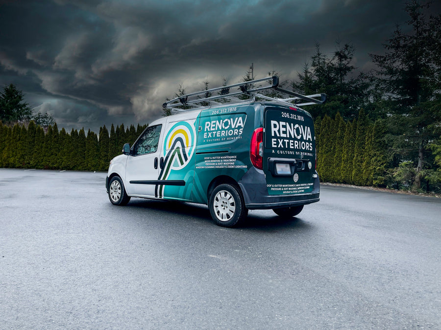 Renova Exteriors Ram ProMaster van with a teal and white wrap, parked under stormy skies