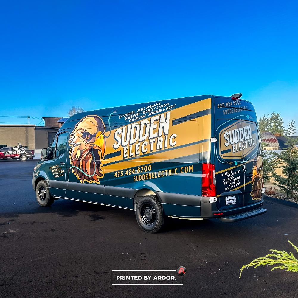 Sudden Electric van with striking eagle design, service offerings like panel upgrades, and company contact details prominently displayed.