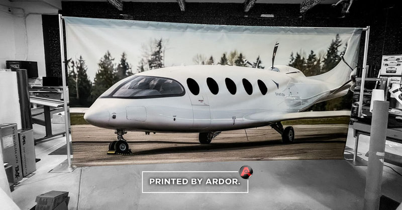 Custom printed fabric backdrop featuring a private jet by Ardor Printing