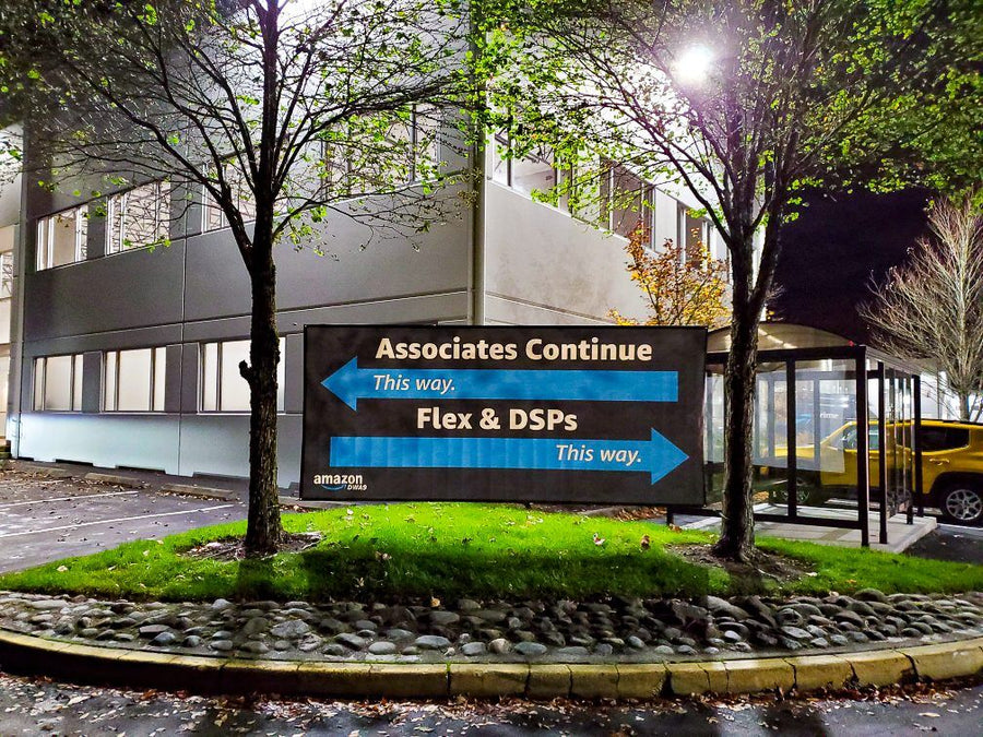 Framed wayfinding banner for associates and drivers outside an Amazon delivery station