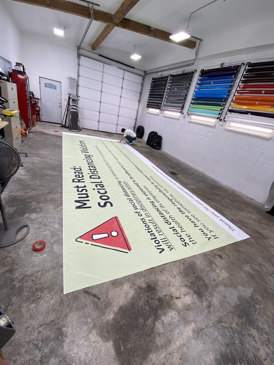 Oversized safety banner for an Amazon delivery station laid out on the Ardor Printing shop floor