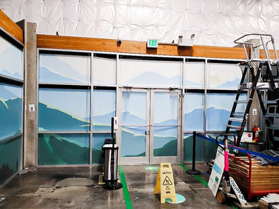 Mountain landscape window graphics covering interior glass at an Amazon delivery station by Ardor Printing