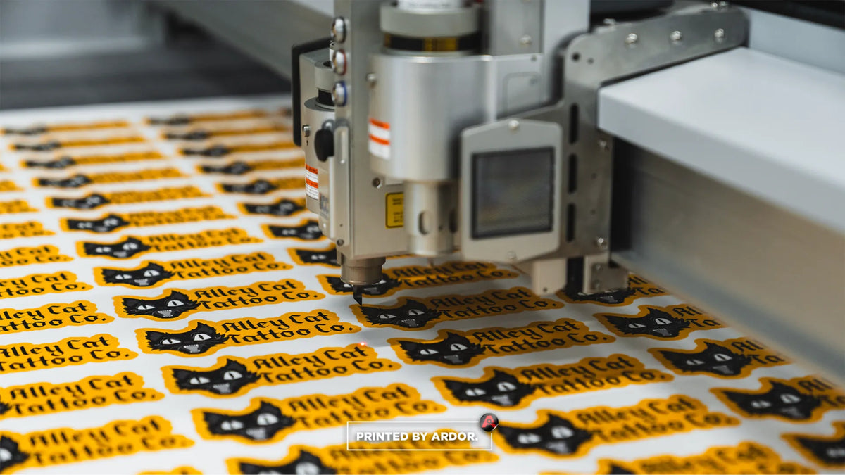 Alley Cat Tattoo Co. die cut stickers being cut on the Zund digital cutter at Ardor Printing in Snohomish, WA