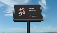 Backlit banner with Ardor Printing branding in a lightbox sign in daylight