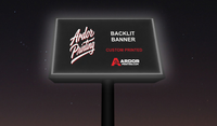 Backlit banner with Ardor Printing branding glowing in a lit lightbox sign at night