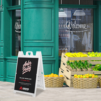 White Deluxe Signicade A-frame sidewalk sign with Ardor Printing branding outside a grocery storefront