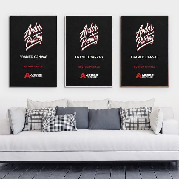 Three framed canvas prints in black floating frames above a sofa