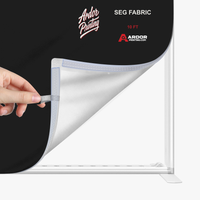 Close-up of the silicone edge fabric graphic being pulled from the 10ft SEG backlit display frame, Ardor Printing branding