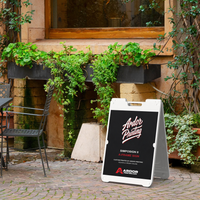 White SimpoSign II A-frame sidewalk sign with Ardor Printing branding on a brick patio outside a building