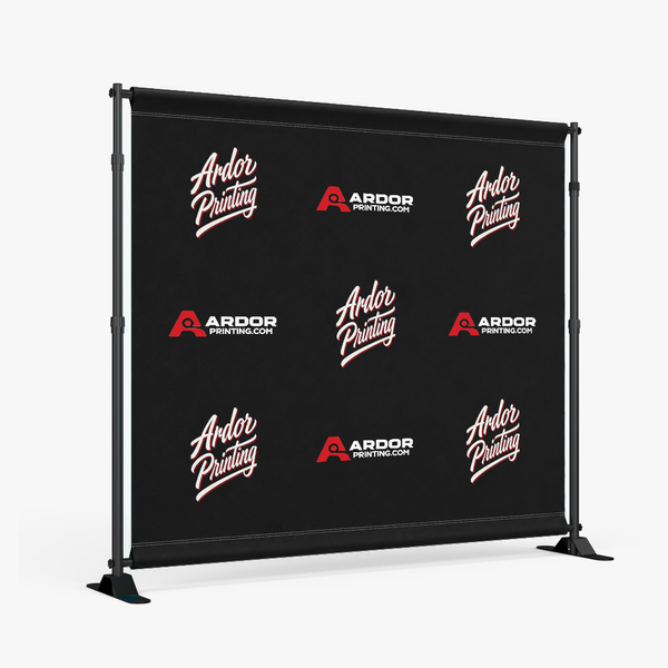 Step and repeat backdrop on a black telescoping frame with a printed fabric graphic showing Ardor Printing branding