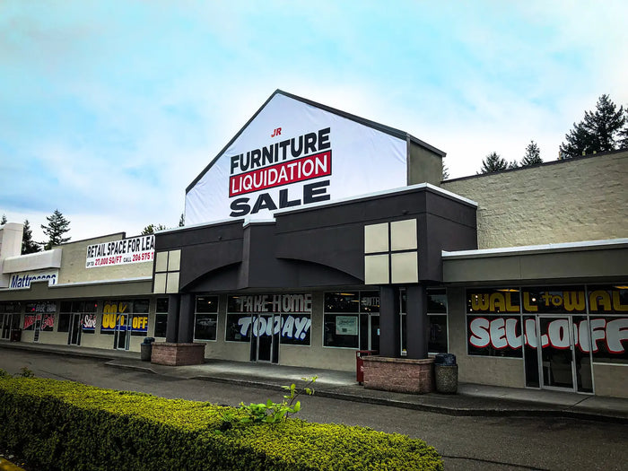 Large building banner for JR Furniture liquidation sale