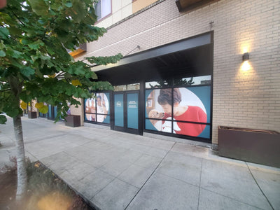 Large lifestyle photo window graphics on a commercial building, view 3 by Ardor Printing