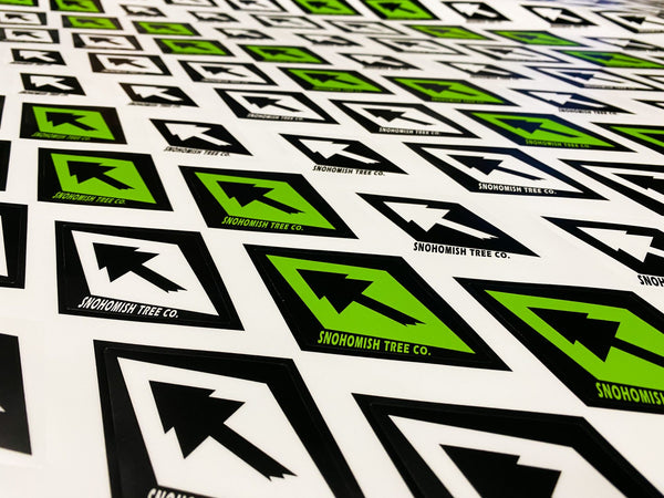 Printed sheet of diamond-shaped black, white and green Snohomish Tree Co. logo decals