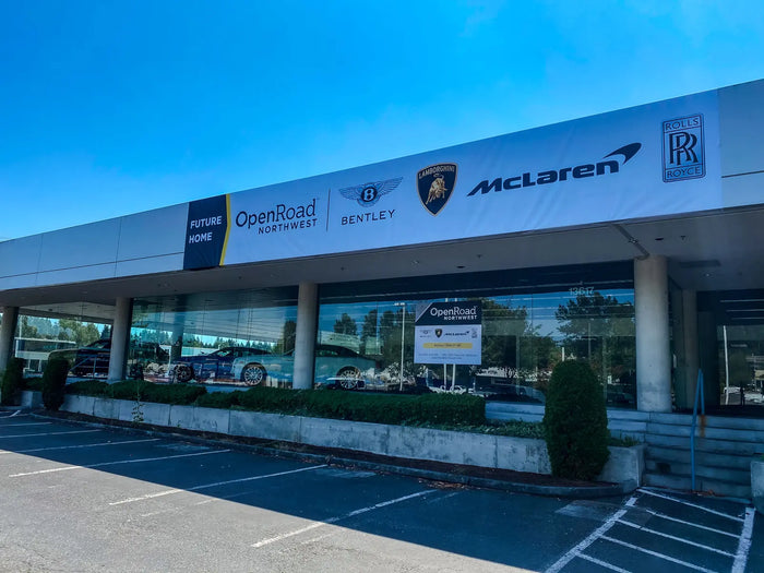 Large vinyl banners on the Openroad dealership building