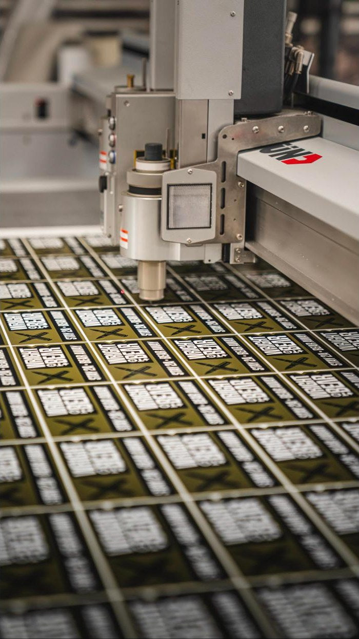 Custom die cut stickers being cut on a Zund digital cutter at Ardor Printing