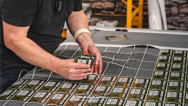 Pulling finished die cut stickers off the Zund cutter at Ardor Printing in Snohomish, WA