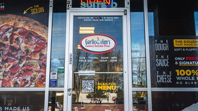 Garlic Jim's pizza storefront with full-color perforated window graphics, view 4 by Ardor Printing