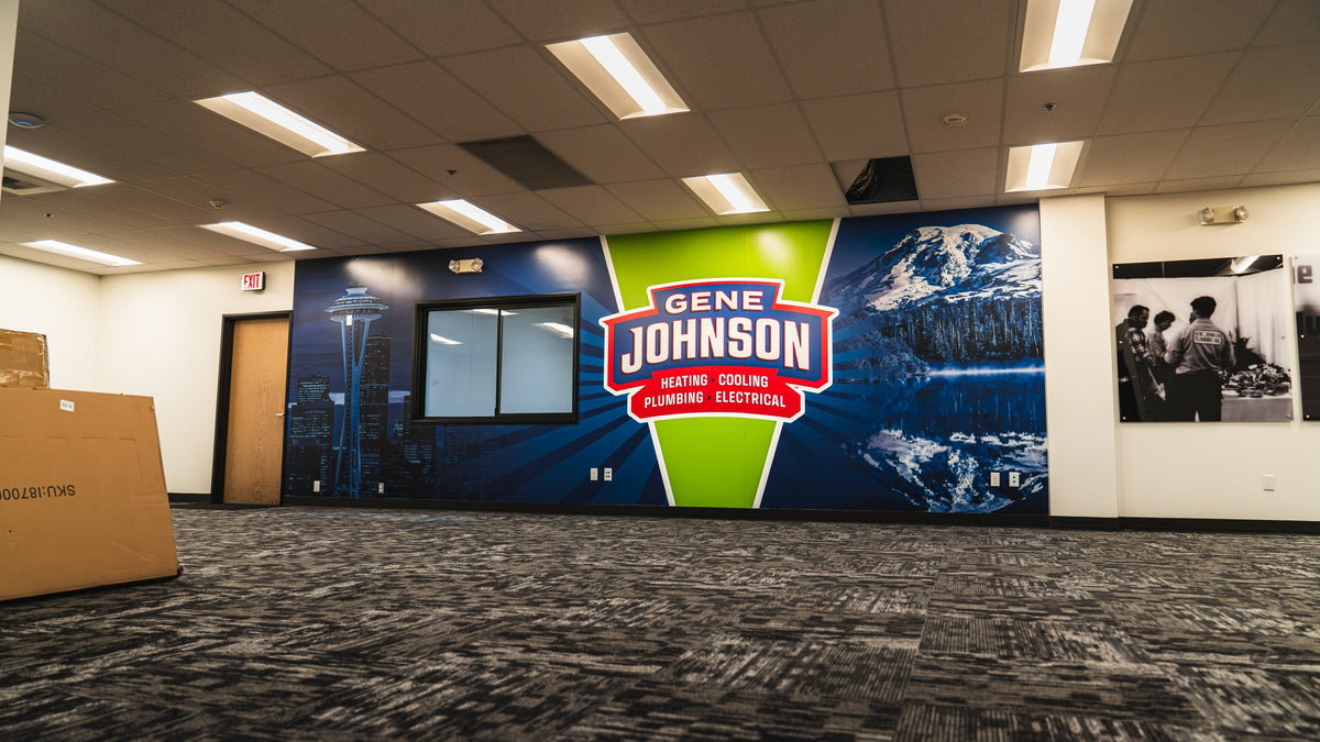 Gene Johnson Plumbing office wall wrap with a large blue logo graphic, printed and installed by Ardor Printing