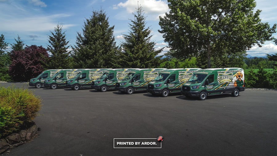 Row of Greenwood Heating Ford Transit vans with matching green fleet wraps by Ardor Printing