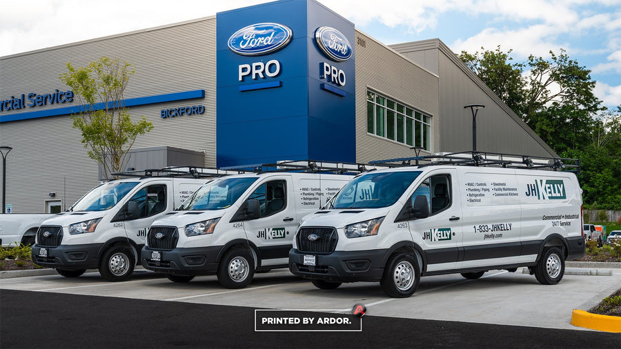 Three white JH Kelly Ford Transit vans with fleet graphics printed and installed by Ardor Printing