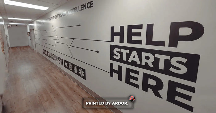 Office hallway wall graphics reading Help Starts Here