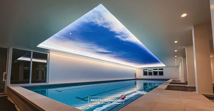 Printed sky mural wrapped on an indoor pool ceiling