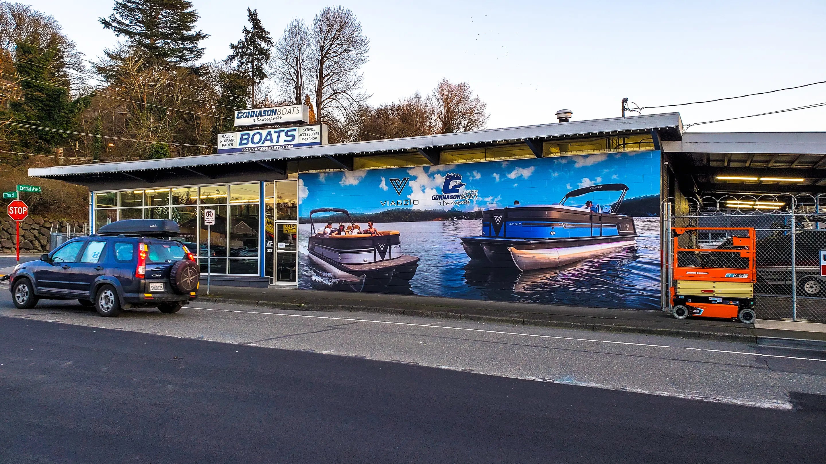 Printed outdoor wall mural we printed and wrapped on the side of Gonnason Boats, Boat Dealership in Seattle, WA